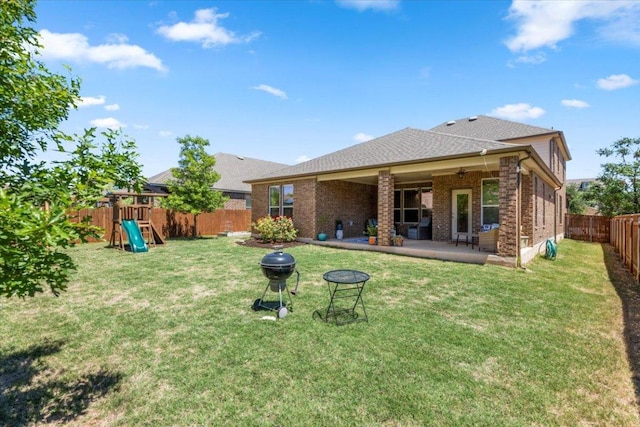 30305 Tiger Woods Dr, Georgetown, TX 78628 - rear view of property with a playground, a patio area, brick siding, ceiling fan, and roof with shingles