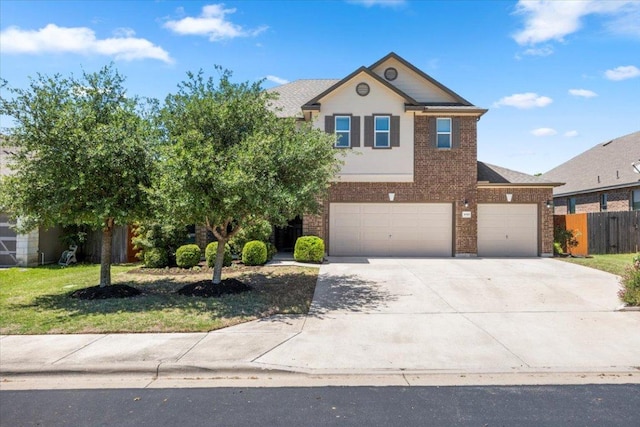 30305 Tiger Woods Dr, Georgetown, TX 78628 - view of front of property featuring brick siding, concrete driveway, and an attached garage