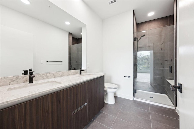 2209 S 1st St Unit 226, Austin, TX 78704 - full bathroom with toilet, a stall shower, double vanity, tile patterned flooring, and recessed lighting