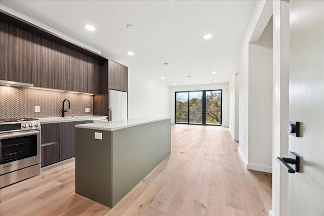 2209 S 1st St Unit 226, Austin, TX 78704 - kitchen with stainless steel range oven, modern cabinets, high end refrigerator, decorative backsplash, and recessed lighting