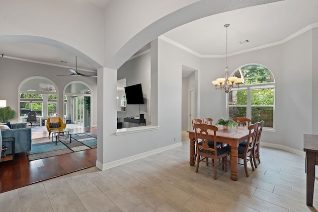dining space with wood finished floors, a wealth of natural light, and ornamental molding