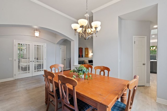 2812 Cascade Falls Dr, Austin, TX 78738 - dining room with arched walkways, ornamental molding, a chandelier, french doors, and light wood-type flooring