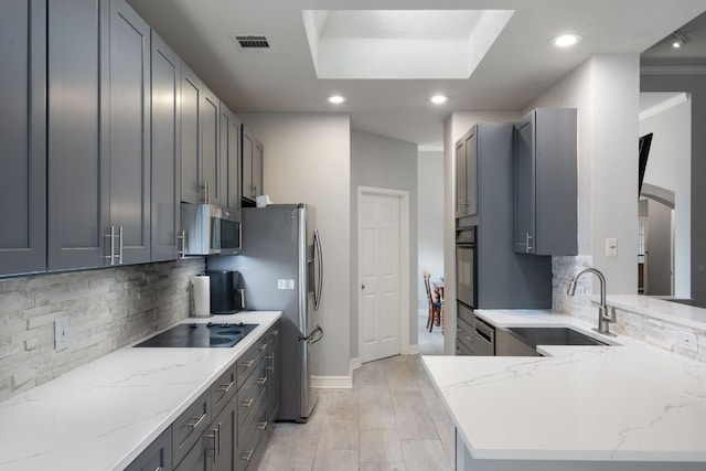 2812 Cascade Falls Dr, Austin, TX 78738 - kitchen featuring black appliances, tasteful backsplash, light stone counters, recessed lighting, and a peninsula