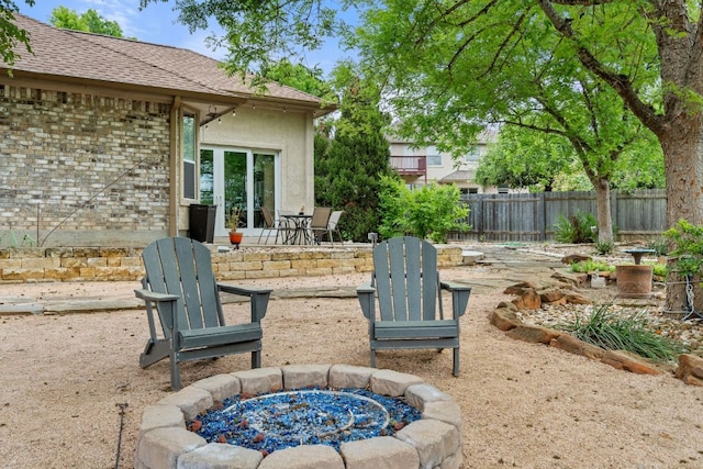 view of patio / terrace with fence and an outdoor fire pit
