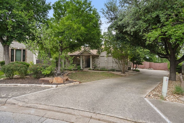 2812 Cascade Falls Dr, Austin, TX 78738 - obstructed view of property with stone siding and concrete driveway
