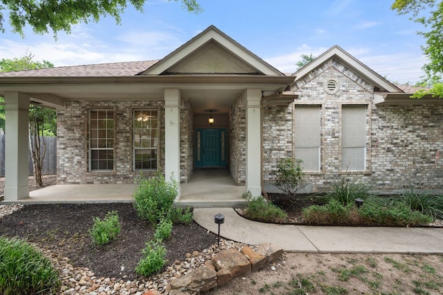 view of front of property featuring brick siding and a shingled roof
