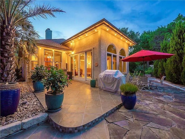 2812 Cascade Falls Dr, Austin, TX 78738 - rear view of property with french doors, a chimney, a patio area, and stucco siding