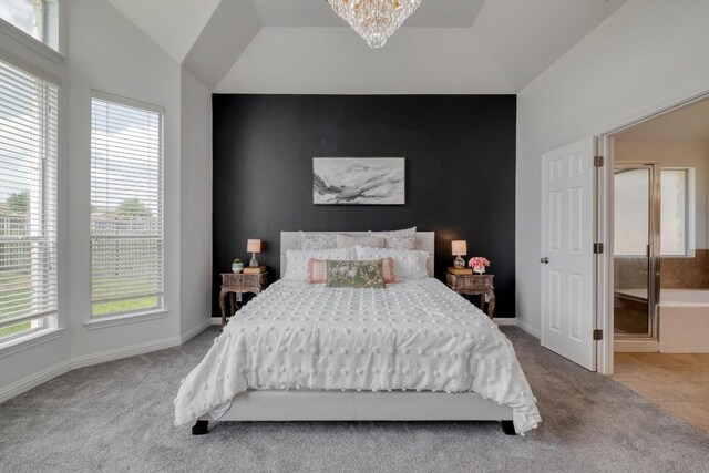 carpeted bedroom featuring an accent wall, vaulted ceiling, baseboards, and a notable chandelier