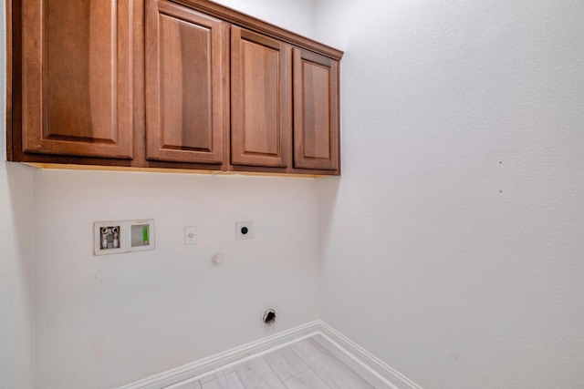 laundry area featuring hookup for an electric dryer, cabinet space, baseboards, hookup for a gas dryer, and washer hookup