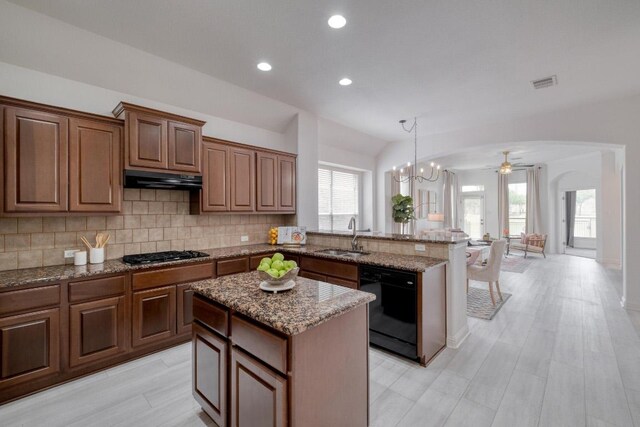 kitchen with black dishwasher, visible vents, a sink, a peninsula, and gas stovetop