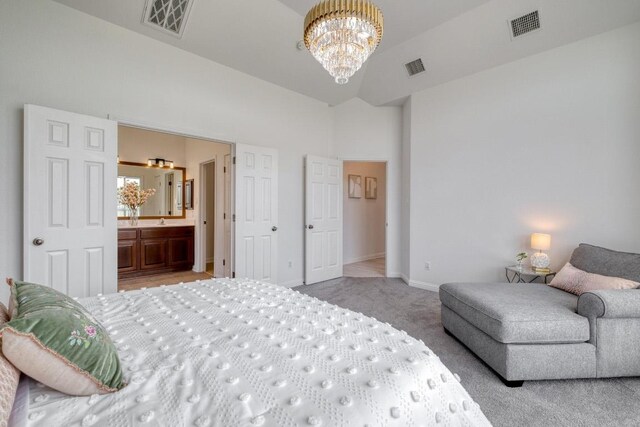 bedroom with visible vents, carpet, a chandelier, and connected bathroom
