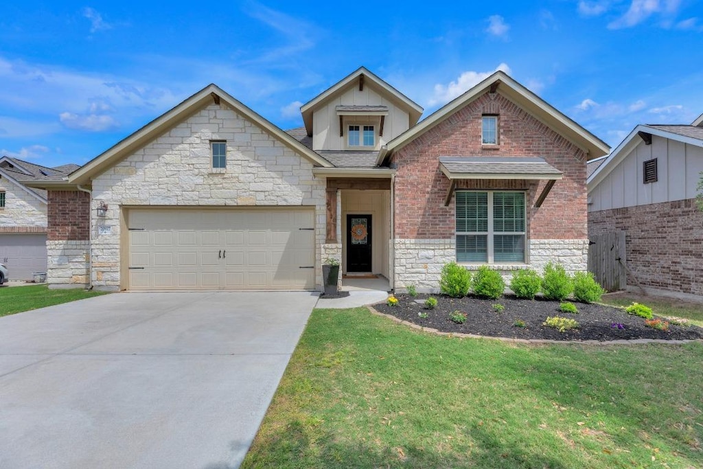 20817 Sand Lark Ln, Pflugerville, TX 78660 - view of front facade with an attached garage, a front yard, concrete driveway, and stone siding