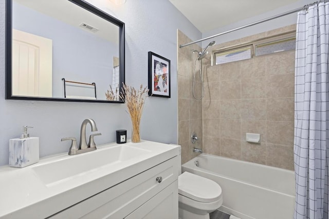 bathroom featuring visible vents, toilet, vanity, and shower / bath combination with curtain