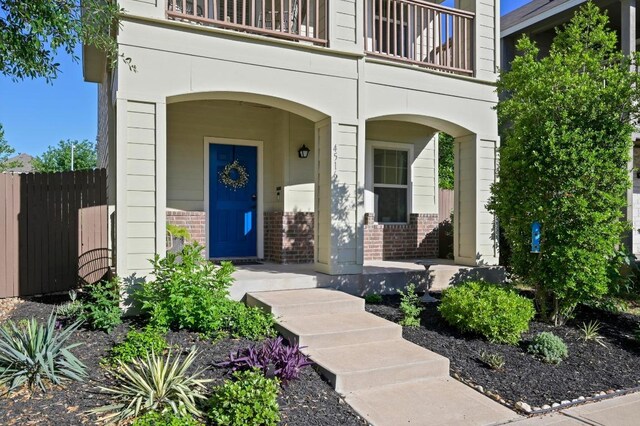 4516 Esper Ln, Austin, TX 78725 - doorway to property with brick siding and a balcony
