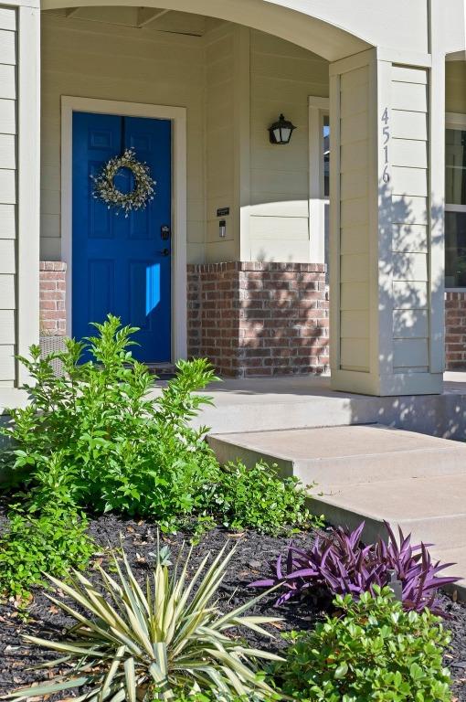 doorway to property featuring brick siding and covered porch