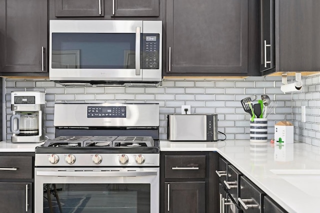 kitchen with a toaster, stainless steel appliances, light countertops, dark brown cabinetry, and tasteful backsplash
