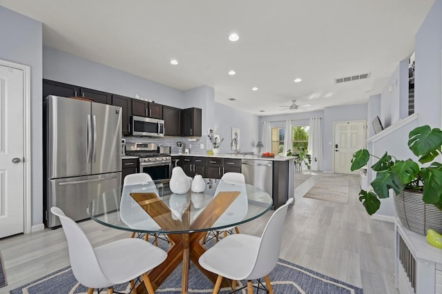 dining space with recessed lighting, light wood-style flooring, visible vents, and a ceiling fan