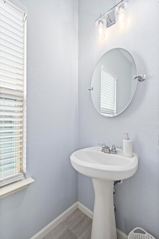 bathroom featuring baseboards and wood finished floors