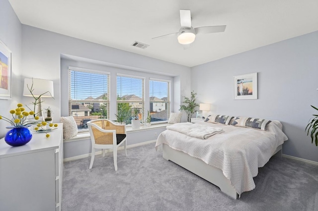 carpeted bedroom with ceiling fan, baseboards, and visible vents