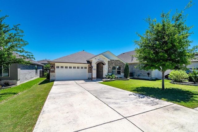 view of front facade featuring concrete driveway, stone siding, a front yard, and a garage