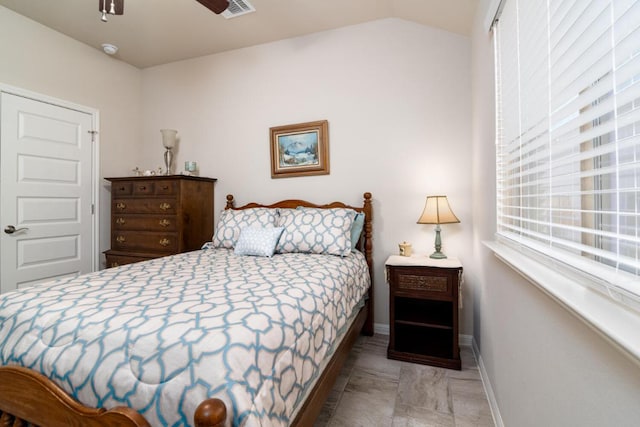bedroom featuring lofted ceiling, visible vents, and baseboards