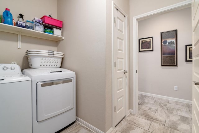 clothes washing area featuring marble finish floor, baseboards, laundry area, and independent washer and dryer