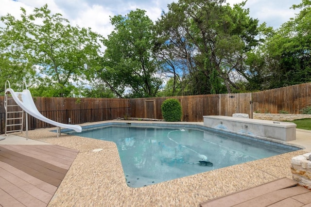 6659 Whitemarsh Valley Walk, Austin, TX 78746 - view of swimming pool with a water slide, a fenced backyard, and a wooden deck