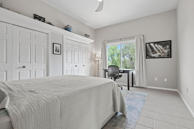 6659 Whitemarsh Valley Walk, Austin, TX 78746 - bedroom with multiple closets, light tile patterned floors, baseboards, a desk, and ceiling fan