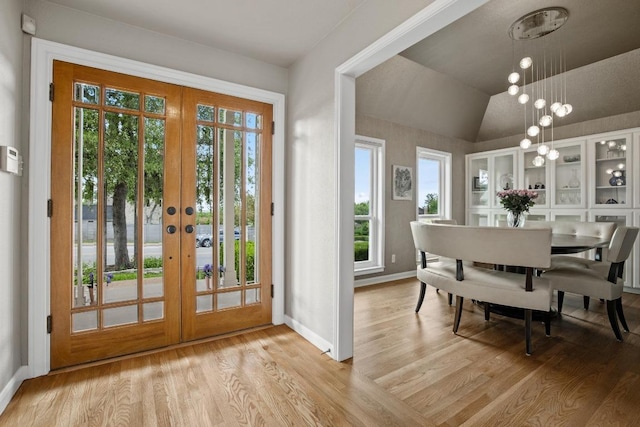 6659 Whitemarsh Valley Walk, Austin, TX 78746 - entryway with french doors, light wood-style floors, baseboards, and vaulted ceiling