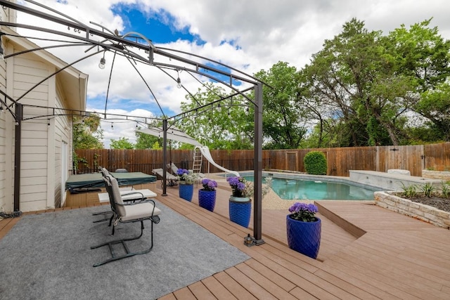 6659 Whitemarsh Valley Walk, Austin, TX 78746 - view of swimming pool with a covered hot tub, a fenced backyard, a water slide, and a deck