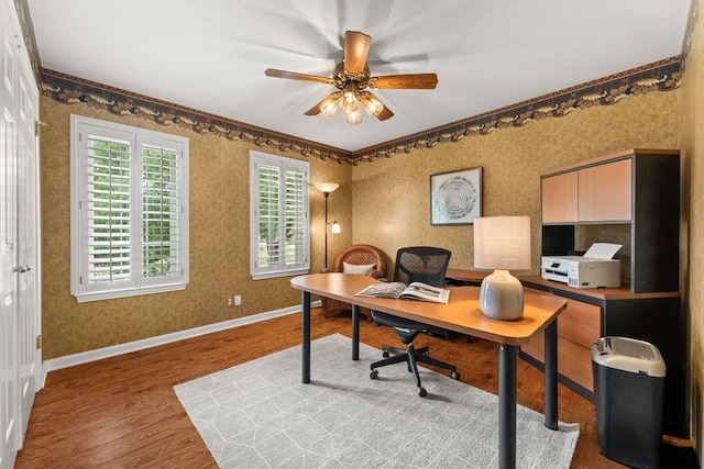 home office with baseboards, a ceiling fan, wood finished floors, and wallpapered walls