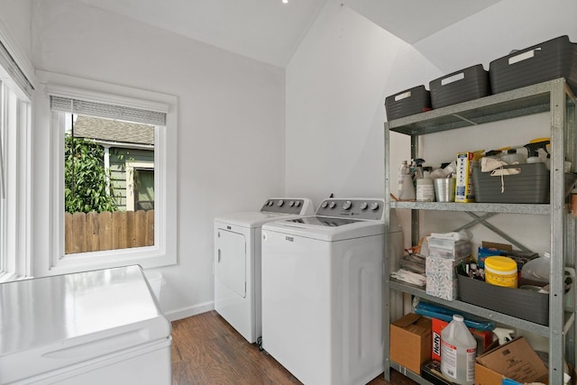 washroom featuring separate washer and dryer, laundry area, and dark wood finished floors