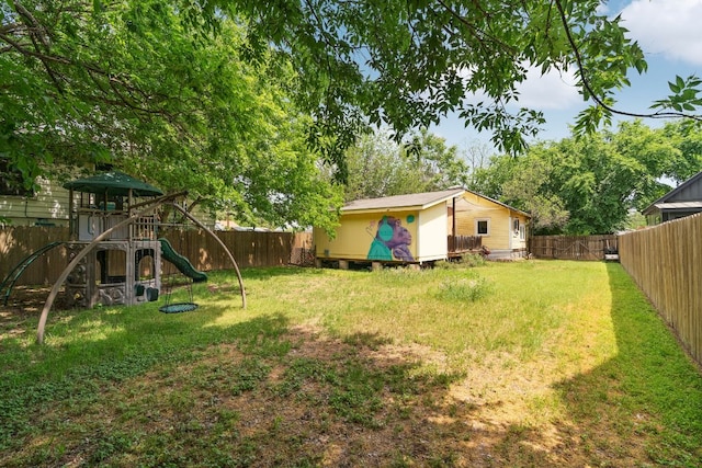 view of yard featuring a fenced backyard and a playground