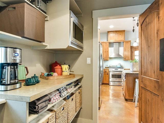 19904 Victoria Chase Rd, Lago Vista, TX 78645 - kitchen featuring appliances with stainless steel finishes, wall chimney range hood, concrete floors, and light countertops