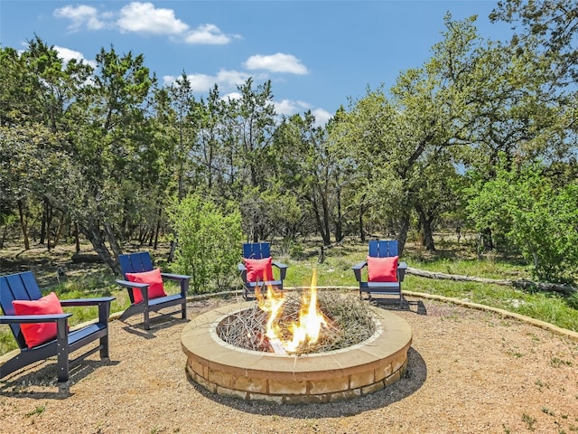 19904 Victoria Chase Rd, Lago Vista, TX 78645 - view of patio with an outdoor fire pit and view of wooded area