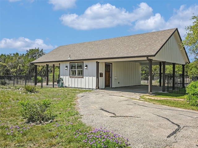 19904 Victoria Chase Rd, Lago Vista, TX 78645 - view of front of home with driveway, an attached carport, roof with shingles, and board and batten siding