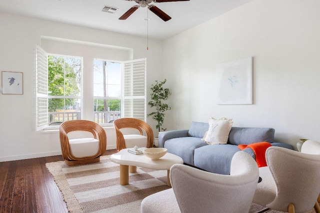 sitting room featuring a ceiling fan, baseboards, visible vents, and wood finished floors