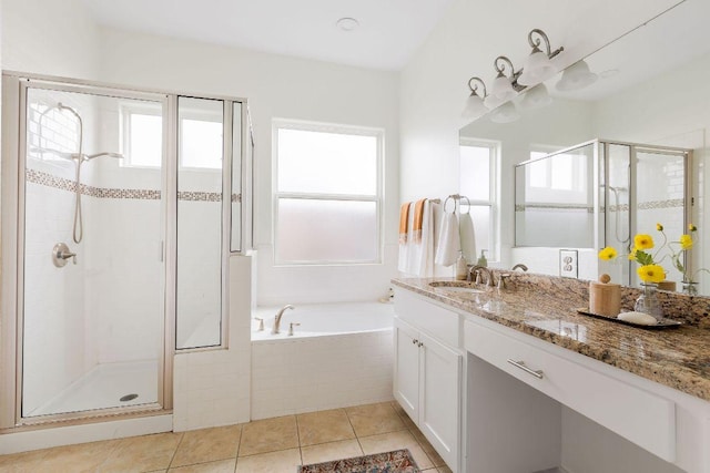 full bath with vanity, tile patterned flooring, a stall shower, and a garden tub