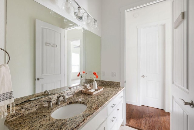 bathroom with wood finished floors and vanity
