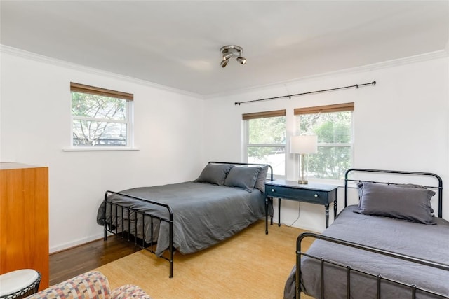 5323 Downs Dr, Austin, TX 78721 - bedroom featuring crown molding, wood finished floors, and baseboards