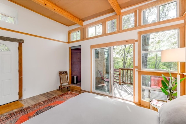 5323 Downs Dr, Austin, TX 78721 - bedroom featuring access to exterior, beam ceiling, and wood finished floors