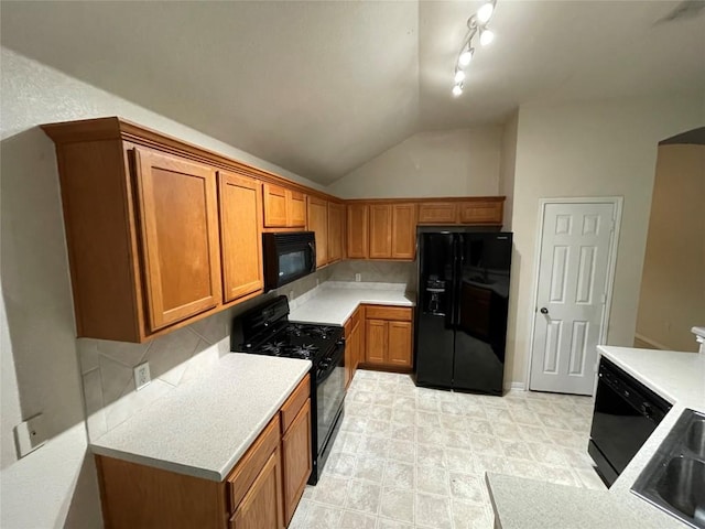 1709 Bush Coat Ln, Austin, TX 78754 - kitchen featuring black appliances, backsplash, brown cabinets, and vaulted ceiling