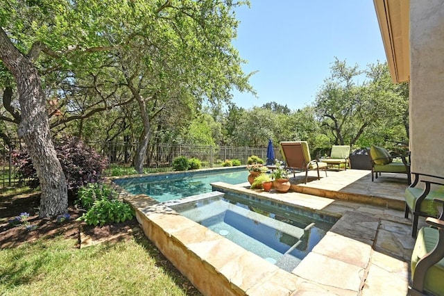 view of swimming pool featuring a patio area, a fenced in pool, a fenced backyard, and an in ground hot tub