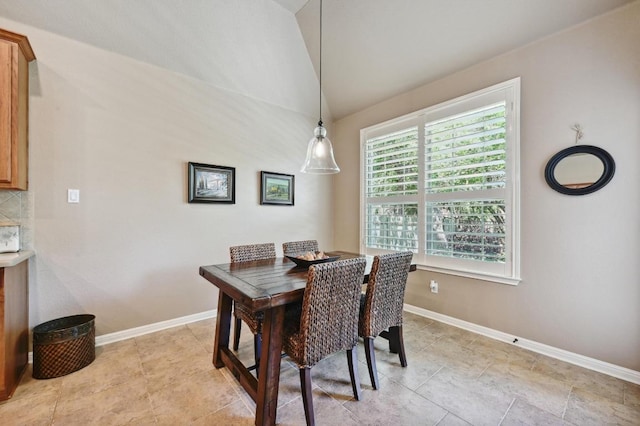 dining area with vaulted ceiling and baseboards