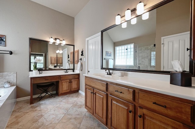 full bathroom featuring two vanities, a sink, baseboards, a shower stall, and a garden tub