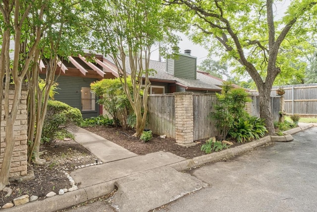 3815 Menchaca Rd Unit 5, Austin, TX 78704 - exterior space featuring fence, a chimney, and a shingled roof