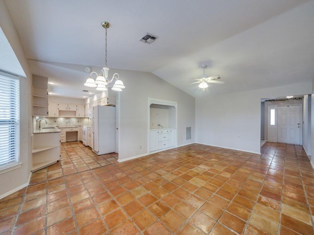 620 Lake Island Dr, Canyon Lake, TX 78133 - interior space with light tile patterned flooring, baseboards, visible vents, lofted ceiling, and ceiling fan with notable chandelier