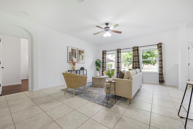 1812 Hidden Springs Path, Round Rock, TX 78665 - living room featuring a ceiling fan, baseboards, arched walkways, and light tile patterned floors