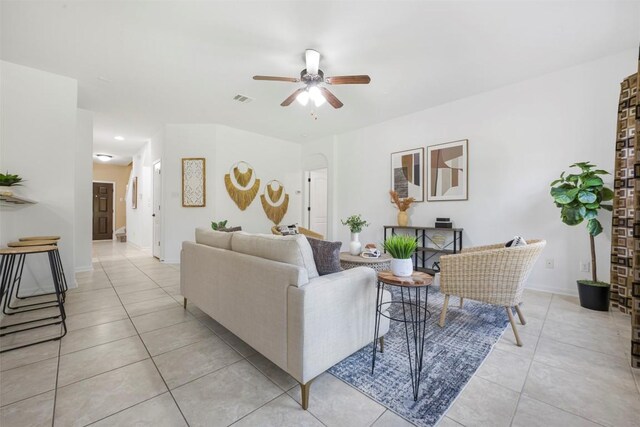 1812 Hidden Springs Path, Round Rock, TX 78665 - living area featuring light tile patterned flooring, ceiling fan, baseboards, and arched walkways