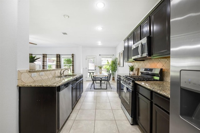 1812 Hidden Springs Path, Round Rock, TX 78665 - kitchen with light stone countertops, stainless steel appliances, a sink, and backsplash